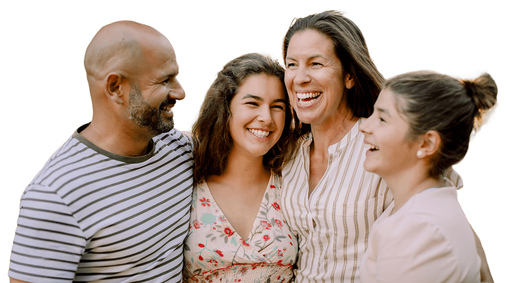Happy family of four smiling and hugging